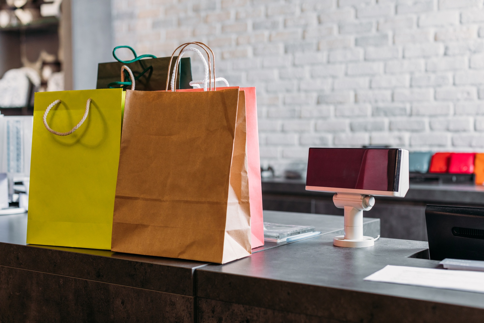 shopping bags standing on cash register in shopping mall, boutique shopping concept
